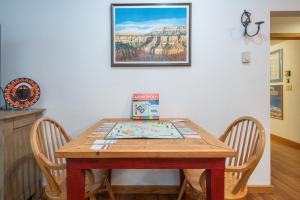 a wooden table with two chairs and a picture on the wall at Riverside Condos D02 condo in Telluride +13 photos