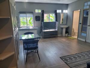 a living room with a glass table and a chair at Hua hin pool view in Hua Hin