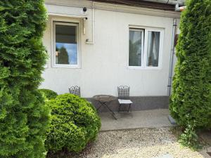 a patio with two chairs and a table in front of a house at La Casa in Sibiu