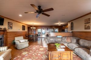 a living room with a couch and a ceiling fan at Alpine Vista in Lenoir