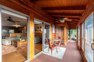 a living room with a ceiling fan and a table at Alpine Vista in Lenoir +27 photos