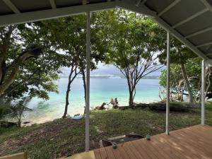 a view of the beach from the porch of a house at Aore Shores Beachfront Bungalow in Aore Island