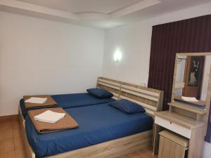 a bedroom with a bed with blue sheets and a mirror at Hua hin pool view in Hua Hin +49 photos