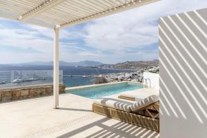 a villa with a swimming pool and a view of the ocean at Casa Kiku Mykonos in Mikonos