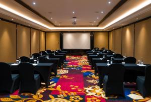 a conference room with tables and a projection screen at Trans Hotel Jakarta in Cibubur +67 photos