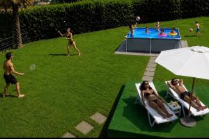 a group of people playing a game of frisbee at Ranco Villa Lina in Ranco