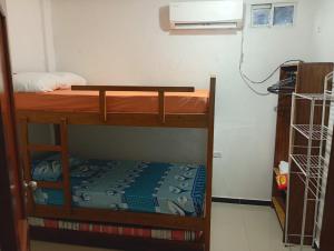 a room with two bunk beds and a microwave at Hospedaje Meriland in Guayabal