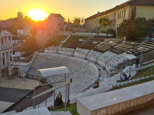 an empty amphitheater with the sunset in the background at XAH - HAN Plovdiv Center in Plovdiv