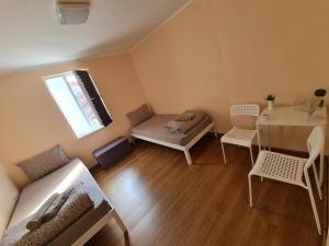a living room with a couch and a table at XAH - HAN Plovdiv Center in Plovdiv
