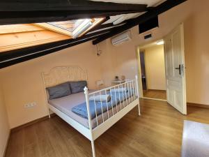 a bedroom with a white crib in a attic at XAH - HAN Plovdiv Center in Plovdiv
