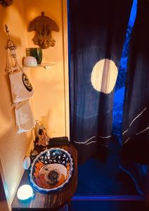 a bathroom with a toilet with a blue curtain at Mitte Lodge 健やかな大人達の田舎ホームステイ1日1組限定で駅送迎と3食家庭料理体験付き in Atami +53 photos
