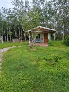 a small house in the middle of a field at Anna Garden Homestay in Ban Phlu Kom