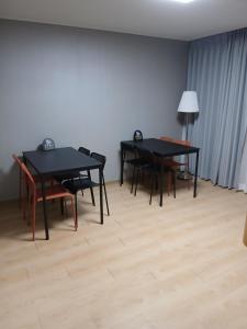 two black tables and chairs in a room at 부산파크호텔 in Busan
