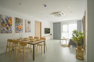 a living room with a dining room table and chairs at TS Apartment in Hanoi