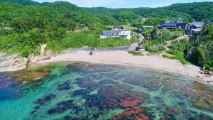 an aerial view of a beach with people in the water at レンタルコテージサントロペ in Kyotango +45 photos