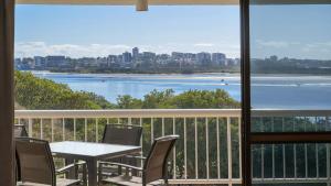 a table and chairs on a balcony with a view of the water at Gemini Resort 55 Stunning Ocean Views in Golden Beach