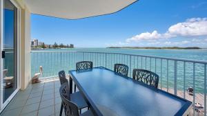 a balcony with a table and chairs and the water at Tripcony Quays Unit 11 in Caloundra