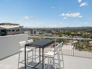 a table and chairs on a balcony with a view at Aurora Pacific Unit 12 in Caloundra