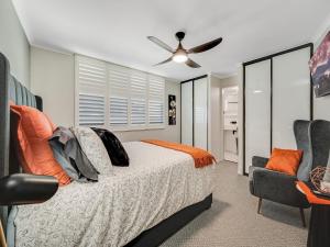a bedroom with a bed and a ceiling fan at Aurora Pacific Unit 12 in Caloundra
