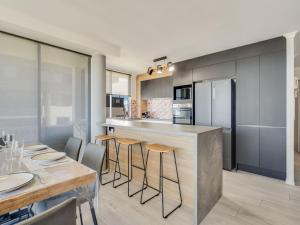 a kitchen with a bar and a table and chairs at Aurora Pacific Unit 12 in Caloundra