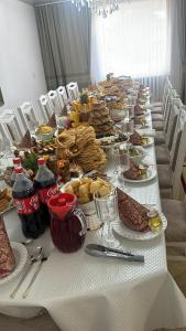 a long table with plates of food on it at Green in Bokonbayevo