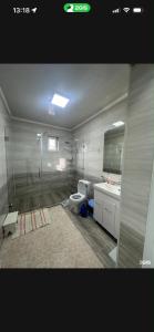 a bathroom with a shower and a toilet and a sink at Green in Bokonbayevo