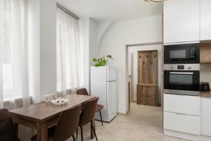 a dining room with a table and a refrigerator at DowntownKate in Debrecen +46 photos