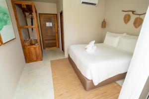 a bedroom with a white bed with a teddy bear on it at The TALAY in Ban Na Tai +40 photos