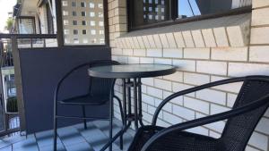 a table and two chairs on a balcony at Beachside Court Unit 9 in Caloundra