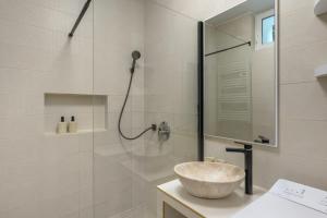 a bathroom with a shower and a bowl sink at DowntownKate in Debrecen