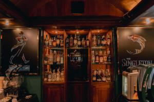 a bar with a lot of bottles of alcohol at The Steuart by Citrus in Colombo +45 photos