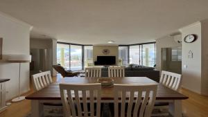 a living room with a wooden table and chairs at The Pinnacles Caloundra Unit 92 in Caloundra