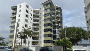 a tall building with cars parked in front of it at The Pinnacles Caloundra Unit 92 in Caloundra