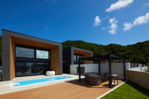 a villa with a swimming pool and a house at Mare Blu Amami in Tatsugo +14 photos