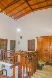 a large room with wooden stairs and a wooden ceiling at Sajee Villa in Hikkaduwa +87 photos