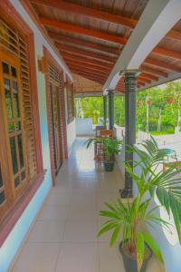 a porch of a house with plants on it at Sajee Villa in Hikkaduwa