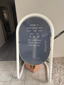 a mirror with a writing on the front of it at Seaside Garden Hotel in Wamberal