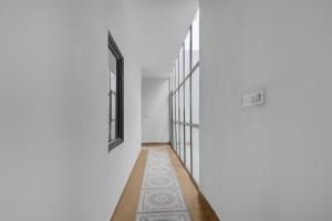 a hallway with a rug in the middle of a room at Collection O Kharar Bus Terminal Formerly Hotel Kamboj in Kharar