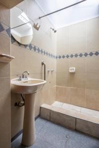 a bathroom with a sink and a shower at SAN BLAS PLAZA INn in Cusco