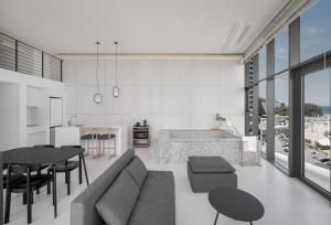a living room with a couch and a table at Plott The Gak Yangyang in Yangyang
