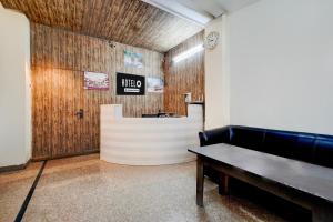 a waiting room with a couch and a table at Hotel O Railway Station Road Formerly Alwar Delight in Alwar