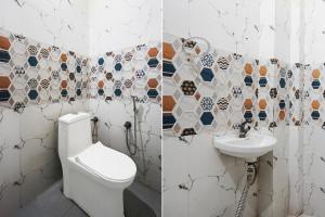 a bathroom with a toilet and a sink at Hotel O Railway Station Road Formerly Alwar Delight in Alwar