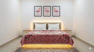 a bedroom with a bed with three pictures on the wall at بانوراما in Zāwiyat ‘Abd al Mun‘im +9 photos