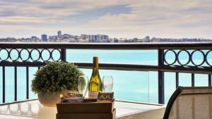 a table with a bottle of wine and a glass at #812 Ramada Resort, Beachfront in Golden Beach +2 photos