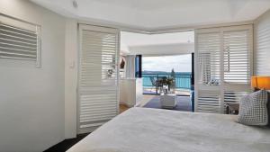 a bedroom with a bed and a view of the ocean at #812 Ramada Resort, Beachfront in Golden Beach