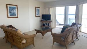 a living room with two couches and a television at Riviere Unit 718 in Golden Beach +8 photos
