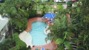 an overhead view of a swimming pool with an umbrella at Riviere Unit 718 in Golden Beach
