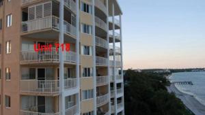 a tall apartment building with a sign that reads vacancy at Riviere Unit 718 in Golden Beach