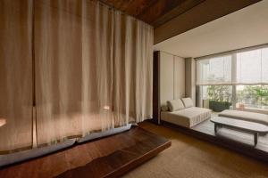 a bedroom with a bed and a large window at KÚON Hakone Gora in Hakone