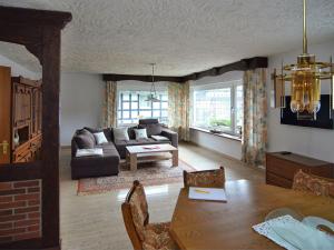 a living room with a couch and a table at Apartment in Assinghausen with a Sun Terrace in Assinghausen